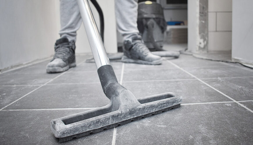 cleaning technician vacuums drywall dust during a post construction cleaning